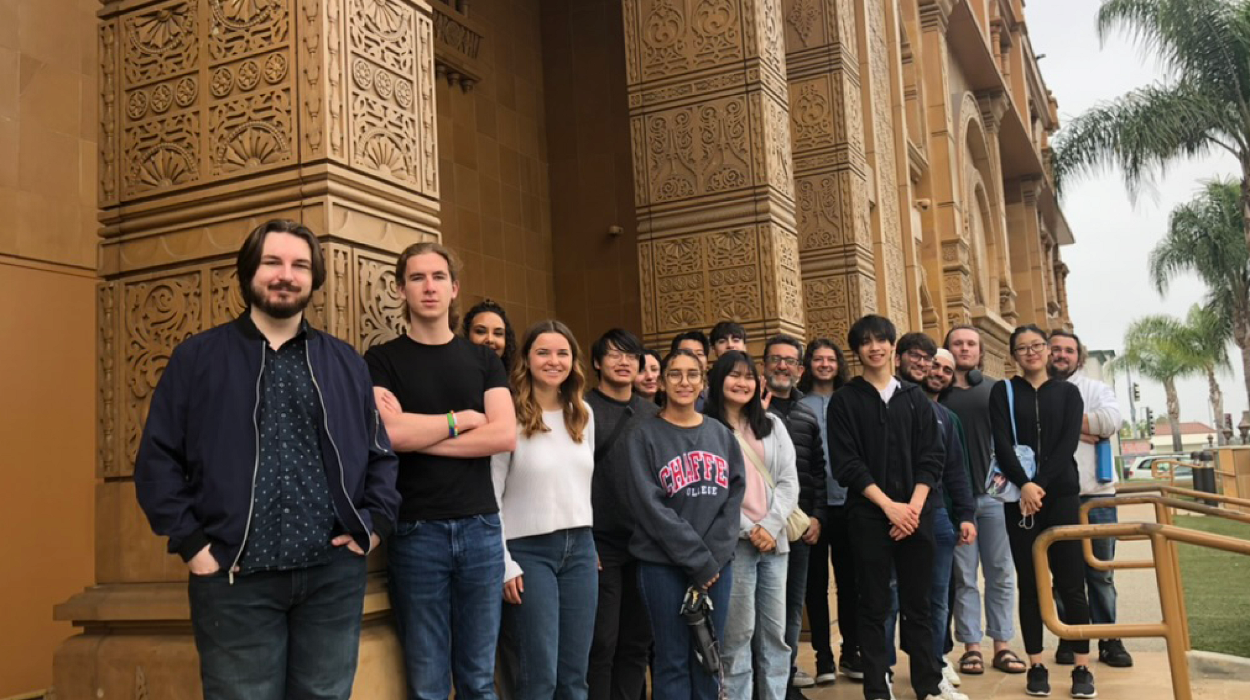 Jain Studies students stand in front of a building at the Jain Center of Southern California.