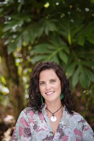 Headshot of smiling woman with dark hair and flowered shirt