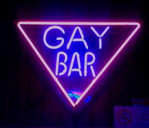 Neon sign with text that says GAY BAR