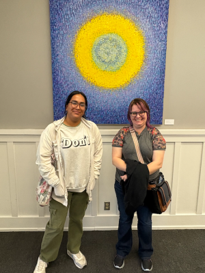 Two students standing in front of art at Muzeo