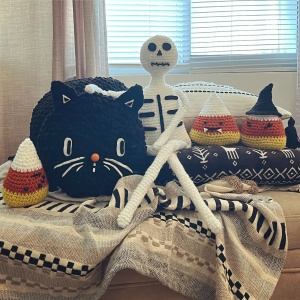 Crocheted candy corn, black cat, and skeleton