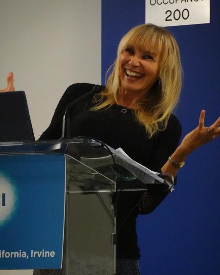 Jayne Lewis standing at a podium