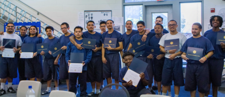 a group of young people holding certificates