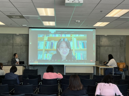 Han Kang on screen with a group of in-person attendees