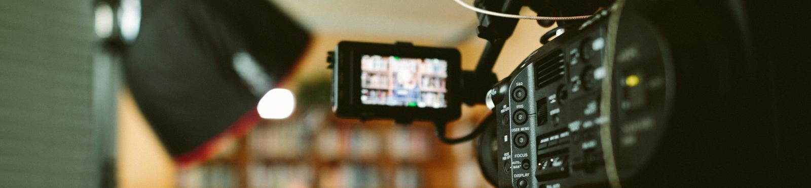 A person recording an interview with a camera