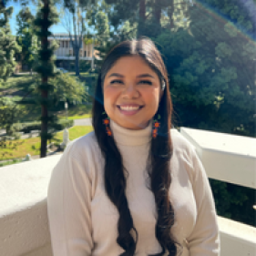 Berenice Tepozano smiling with a white railing behind her