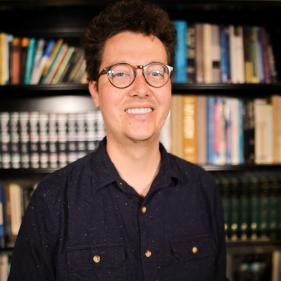 A headshot of Trevor Redd Smith