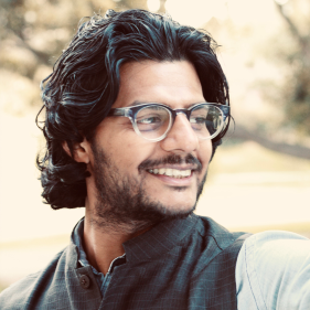 Head shot of Anirban Gupta-Nigam in a park