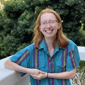 a woman in a blue stripe shirt, smiling