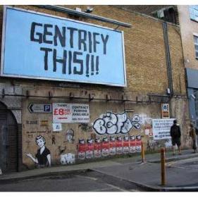 Building with sign "GENTRIFY THIS"