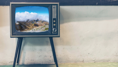 A retro television displays a landscape shot of a mountainous region