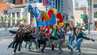 Group of art history students posing silly in front of SFMOMA