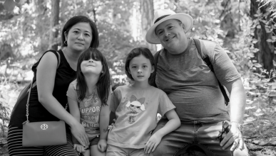 Rodney Hironymous, his wife and two daughters posing for a photo