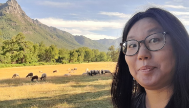 Isabel Wu posing with sheep in Chile