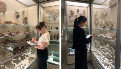 Melissa DePierro and Maddy Hua taking notes and looking at artifacts.