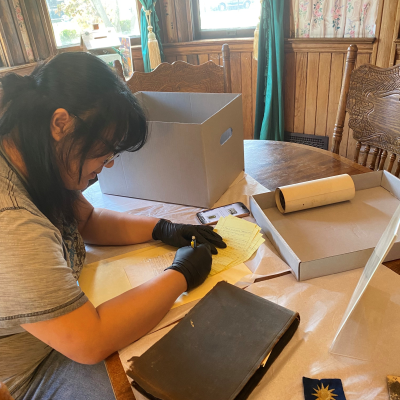Sofia Babiera is writing and doing research on a desk.